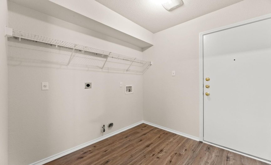 Laundry room features connections for either a gas or electric dryer, washer, and wire shelf/rack for extra storage.