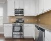 Sleek stainless steel appliances include a gas range, microwave and dishwasher. 