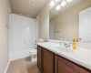 The full secondary bath room upstairs comes with a spacious vanity and a shower/tub combo with tile backsplash. 