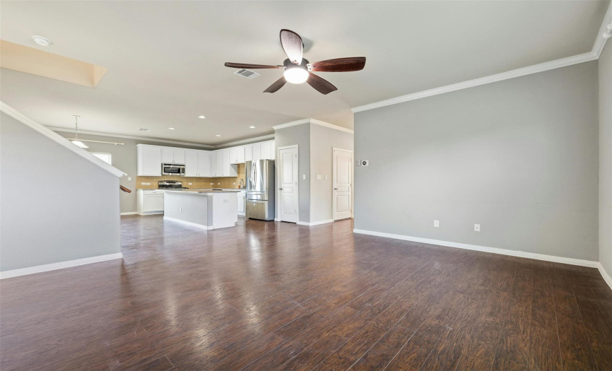 The main floor features tall ceilings wrapped in crown molding and gorgeous engineered hardwoods.