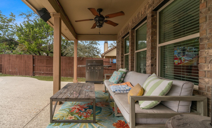 The porch provides plenty of space for you to configure your ideal outdoor living space with a breezy overhead fan. 