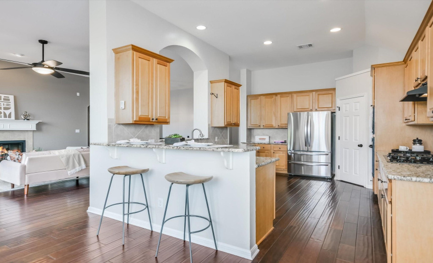 Indulge in gourmet meals prepared in this well-appointed kitchen, complete with sleek granite countertops, stainless appliances, and a convenient breakfast counter for casual dining.