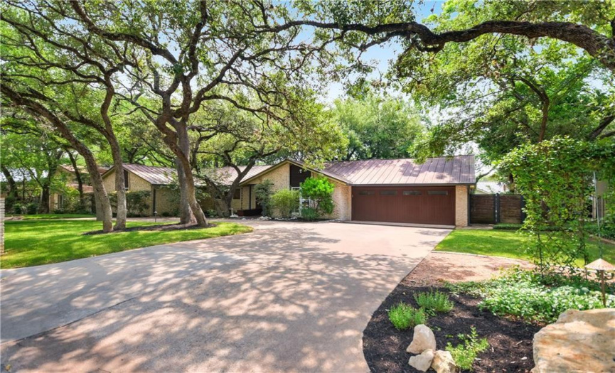 Experience convenience and elegance with the circular driveway leading to the attached 2-car garage, providing ample parking and easy access to your beautiful West Lake Hills sanctuary.