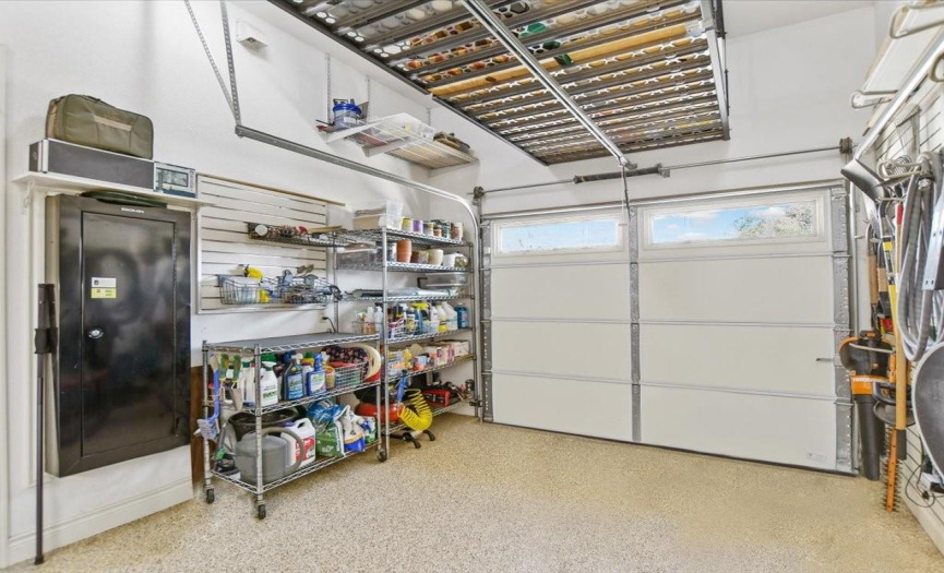 Golf cart garage has air and heat. Yes, that is a gun safe built in that will convey. in the 2 car bay is a central vacumn system for the house.