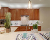 Kitchen features include quartz countertops and over & under cabinet lighting.