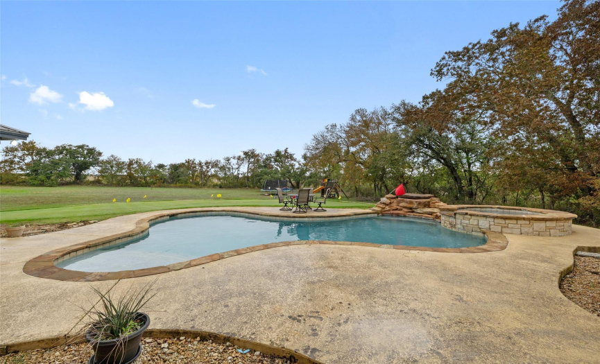 The beautifully designed pool deck is surrounded by lush professional landscaping while mature trees provide an additional screen of privacy. The pool includes a removable child safety fence. 
