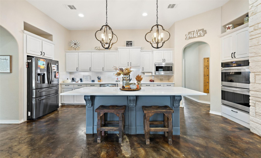 Everyone will want to gather around the center island with wrap around breakfast bar seating and plenty of space for preparing and serving meals. 