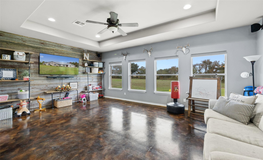 Dual archways off the dining area lead into this luminous family room, nestled away in the back corner of the home with a wall of windows maximizing the views of your surrounding acreage. 