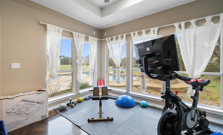 The primary suite also provides this bonus sitting room wrapped in walls of windows with amazing views. Perfect for a nursery, home office, fitness area, and more! 