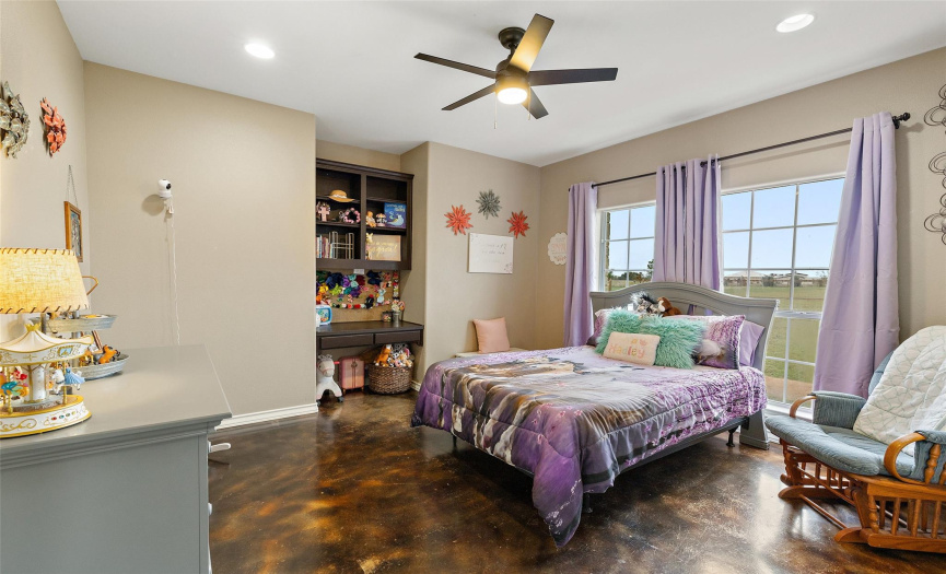 Three secondary bedrooms are secluded away in their own wing on the left front side of the home alongside a full secondary bathroom. This room offers a charming study niche. 