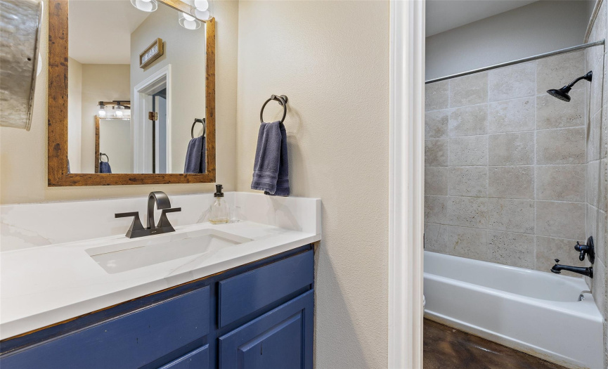 This spacious secondary bathroom offers two separate vanities plus a separate water closet with the shower/tub combo & commode. 