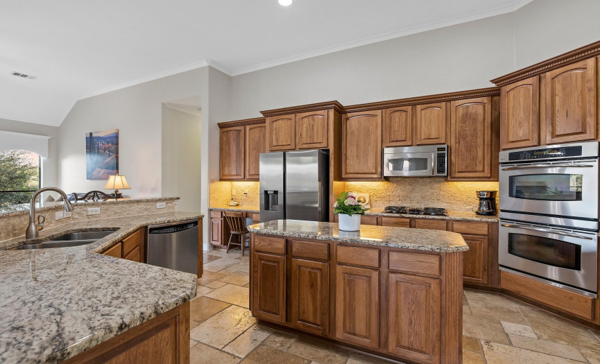 A kitchen for pure joy - stainless appliances, double ovens, ample wood cabinetry and gas cooktop.
