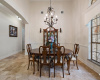 Spacious dining area with elegant lighting and travertine flooring, ready for family meals and gatherings.