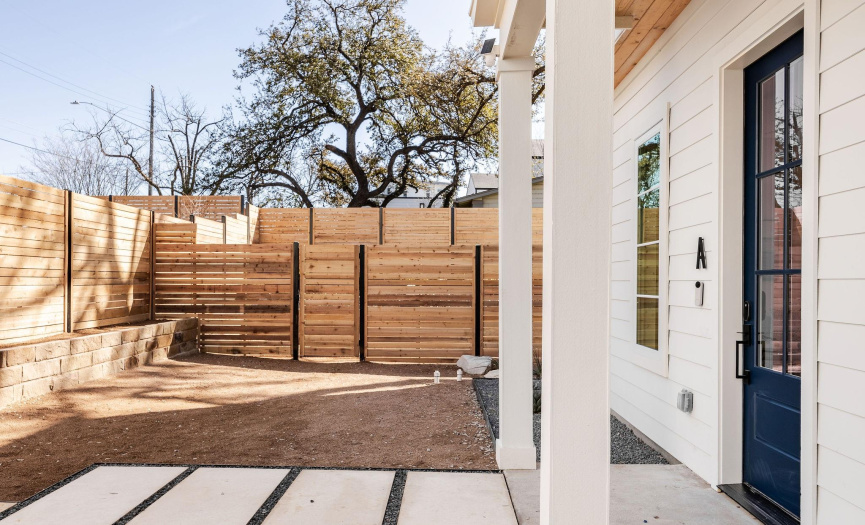 Covered front porch with gate access to private backyard.