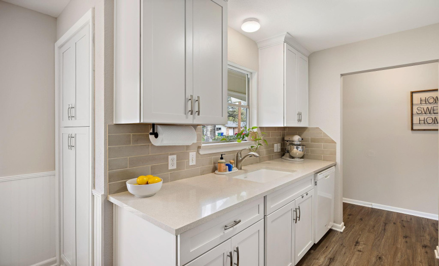 A neutral tile backsplash elevates the kitchen design.