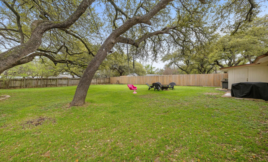 Numerous well-maintained, mature oak trees blanket the yard, offering a stunning view and desirable shade during the hot summer months