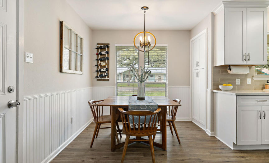 The dining area is complete with dual windows showcasing a view of the tree-lined community.