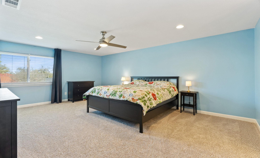 Escape to the primary bedroom, providing plush carpeting and ample space to unwind after a long day.