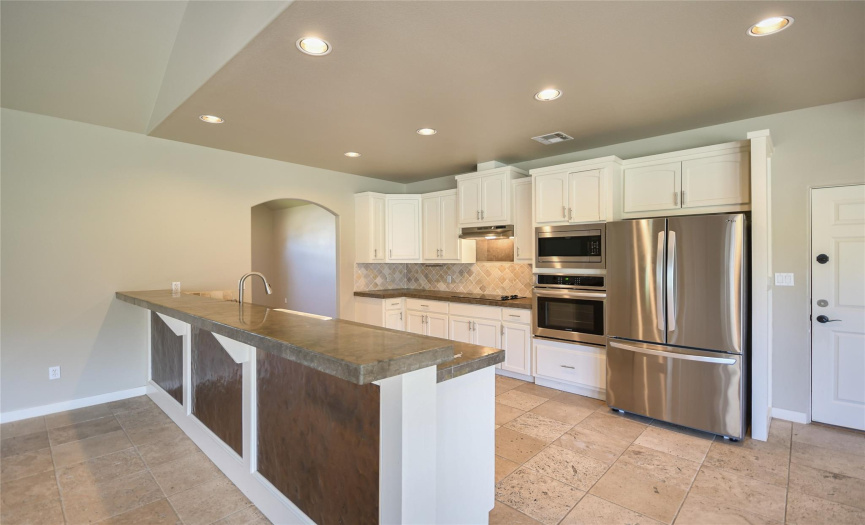 Granite Counters, Ample Cabinets and Prep Space + Stainless Appliances accent the Kitchen.