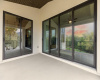Spacious covered patio with walls of sliding doors.