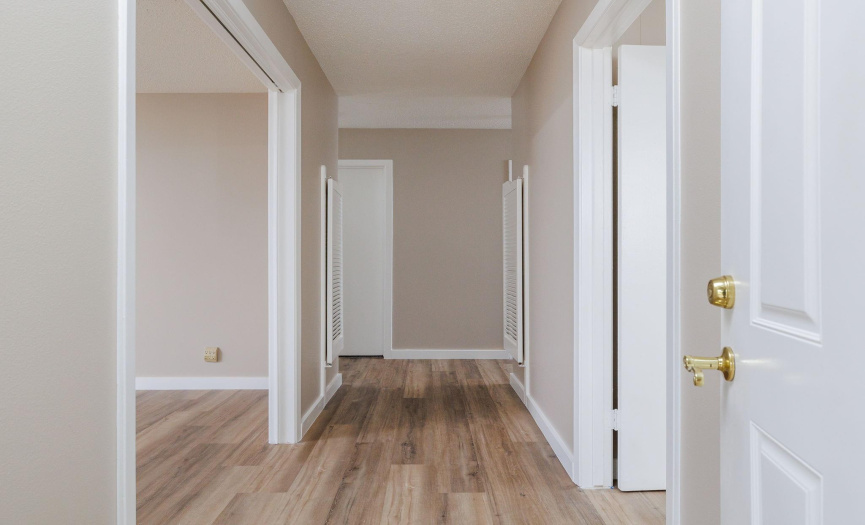 Upon opening the front door, a short hallway takes you to the formal living (to the left), the kitchen / informal living (to the right), or to the bedrooms (straight ahead).  LVP is continued through the entire house.