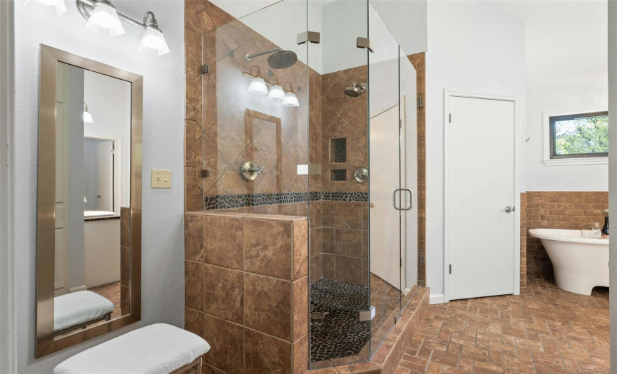 This bath includes a dual vanity, standalone soaking tub, and a walk-in shower