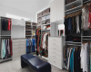 Huge walk-in closet built-out with custom California Closet system