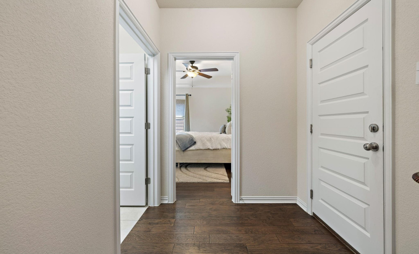 This 3rd secondary room sits on its own on the right side of the home. The door on the right leads to the garage and the door on the left is the laundry room.