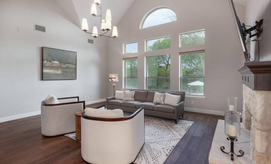 Family room with window view, high ceilings and fireplace