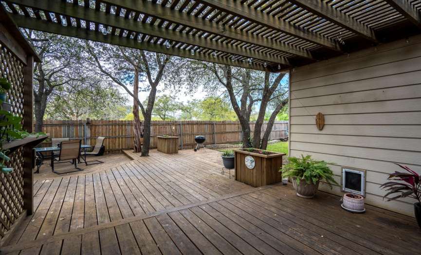 Expansive outdoor living! Multi-level decks with seating areas, planter boxes and shade! (The lot behind the home is a privately owned residence on acreage.)
