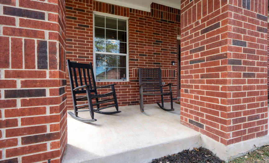 Pull up and rock away on this cozy front porch. 