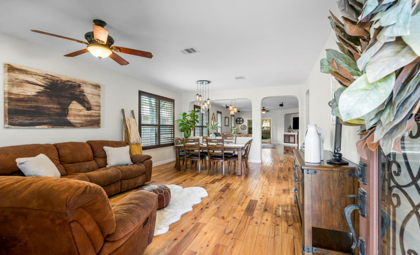 The home greets you with gorgeous hardwood floors, an open floor plan, plantation shutters and ample living space.