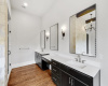 Primary bathroom with vanity area, soaker tub, oversized shower,  towel warmers and custom designed his and hers closets.