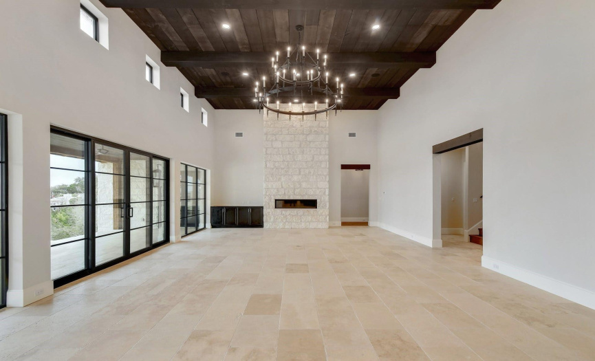 Family room features floor to ceiling fireplace 