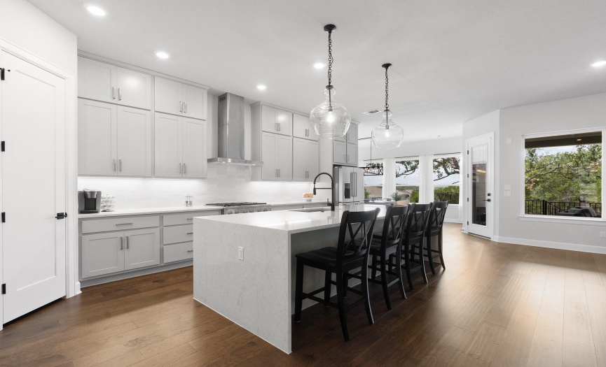 The gourmet kitchen is full of luxuries - with a stunning granite waterfall island and top-of-the-line appliances.