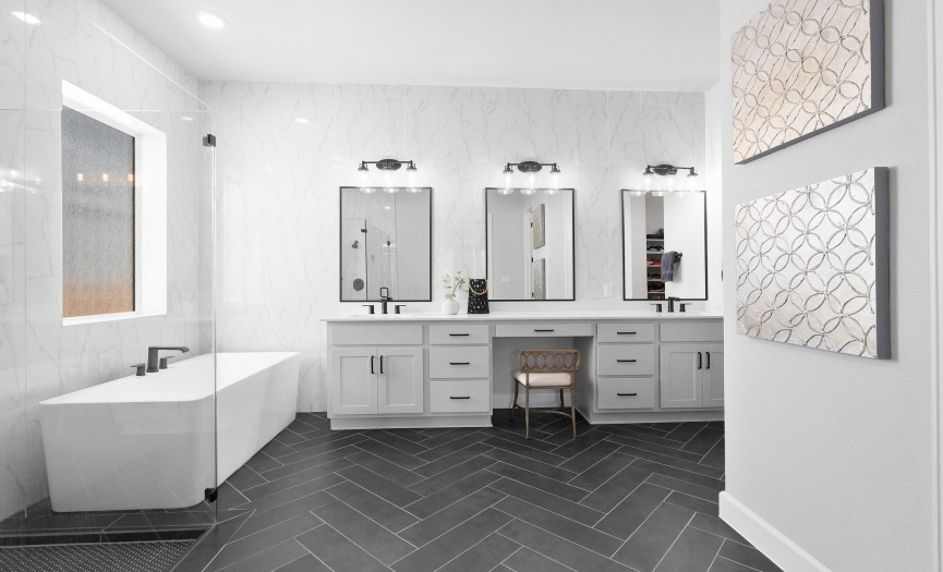 The main bathroom features a dual sink vanity, a spacious walk-in shower and a separate water closet combining functionality with modern luxury.