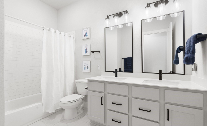 The guest bathroom boasts an upgraded dual sink vanity with plenty of room for your morning routine, making it a great way to start your day.