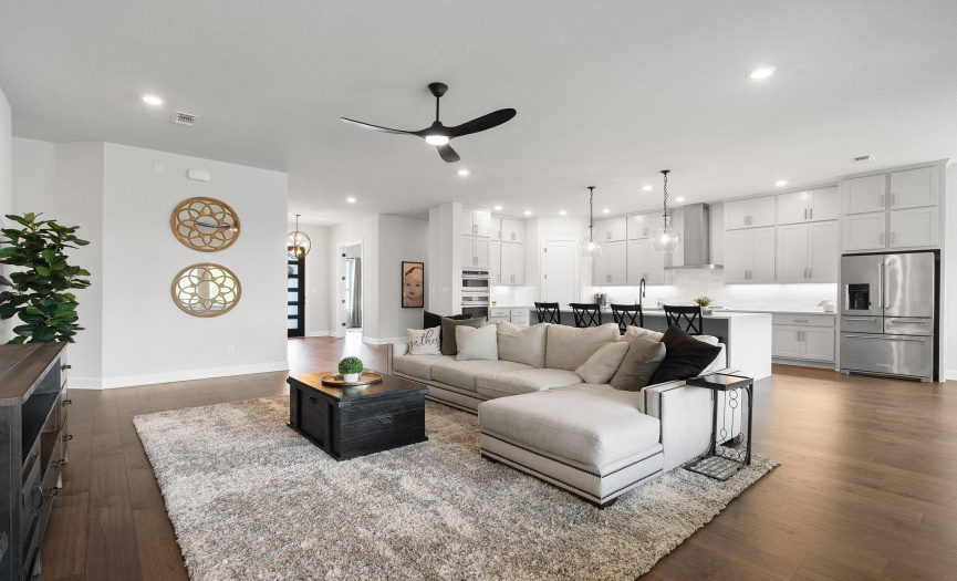 Stunning open living space withan upgraded modern ceiling fan.