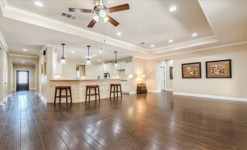 Wood floors and tray ceilings throughout this home gives it so much charm and style. 