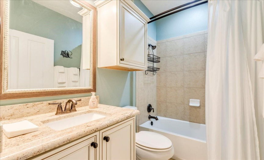 Full guest bathroom with custom cabinetry. 