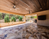 Texas sized patio with tongue and grooved ceiling, flagstone flooring and outdoor TV. 