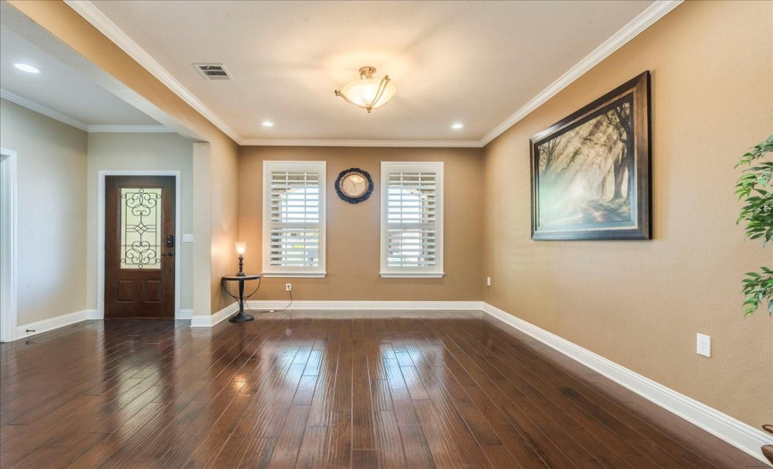 Large formal dining room with windows to the front porch. 