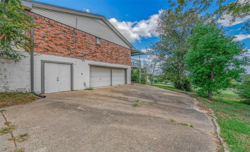 Oversized garage has room for riding mower or golfcart.