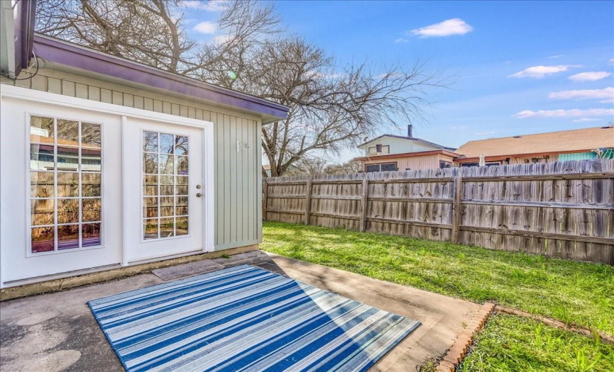 Rear patio perfect for a BBQ and private fenced backyard. 