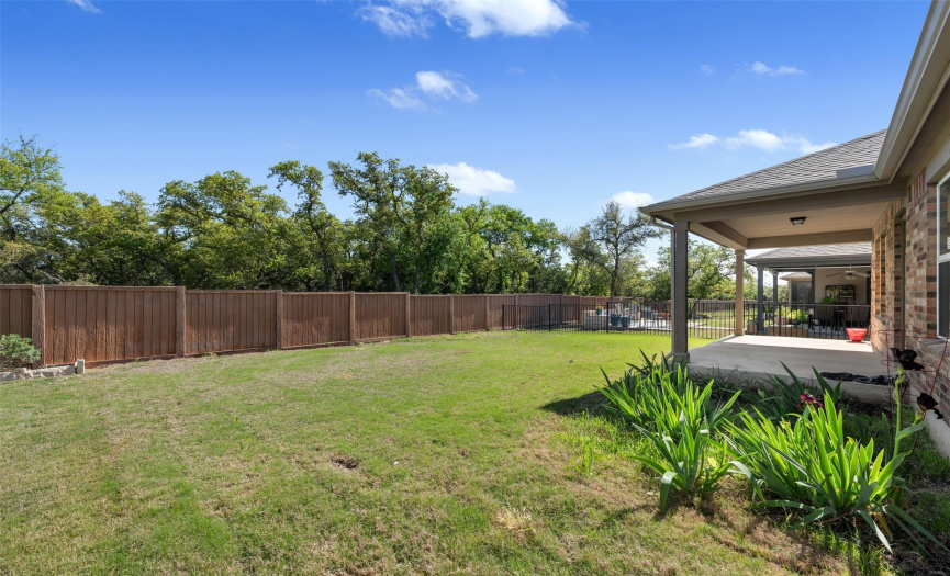 Beautiful backyard looks onto green space that does not have homes behind.  Home features a covered back patio.