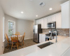 Spacious open kitchen with gas cooktop, stainless appliances, and large oversized sink.