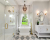 The elegant primary bathroom with soaking tub and oversized shower.