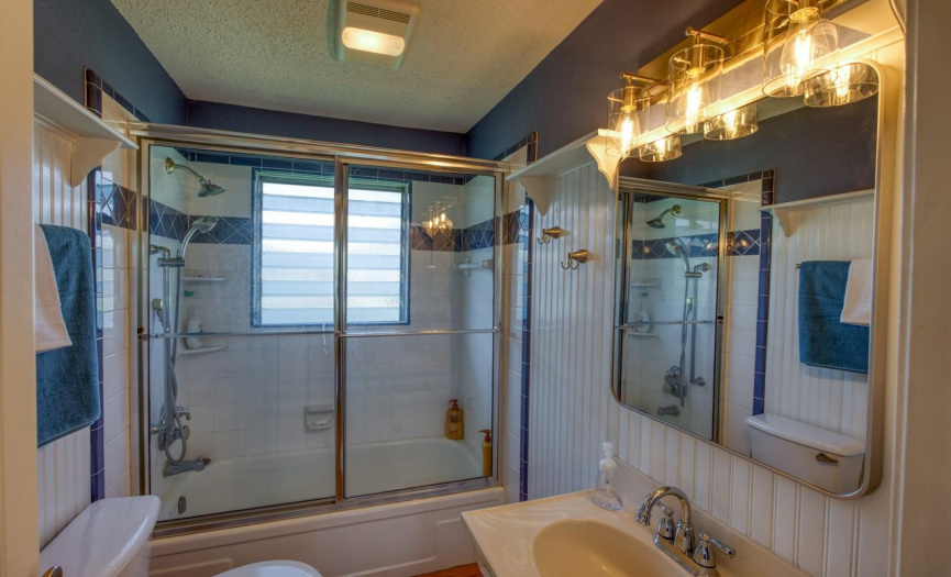 The guest bathroom provides a well-appointed space for visitors to freshen up and unwind during their stay in this waterfront retreat.
