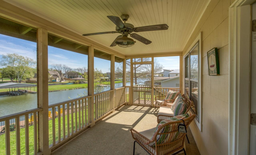 Step onto the upstairs screened-in porch and immerse yourself in the beauty of the serene surroundings, offering a peaceful retreat with stunning views of Lake LBJ.
