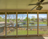 Relax and unwind on the upstairs screened-in porch, an ideal spot for enjoying the fresh air and picturesque views.